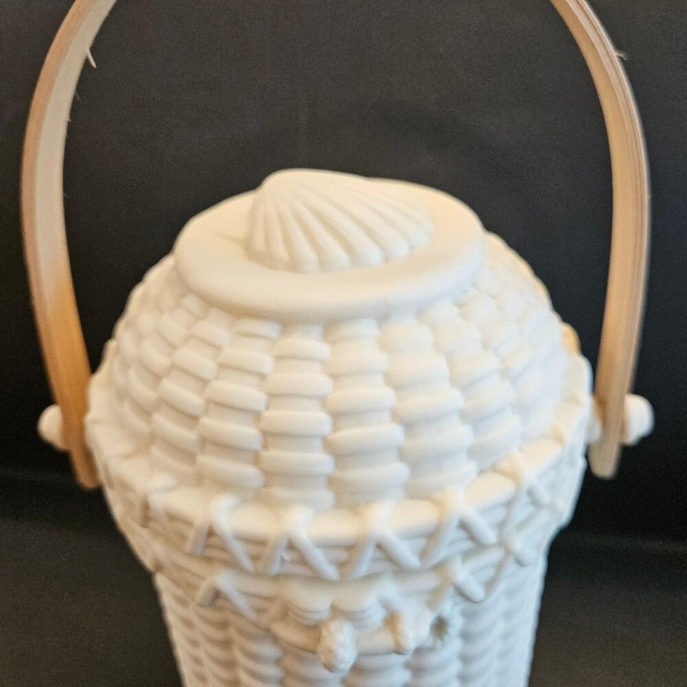 Partylite porcelain woven basket design w/ seashell on lid; wooden handle.
